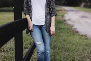 WOMAN WEARING A CARDIN OVER JEANS